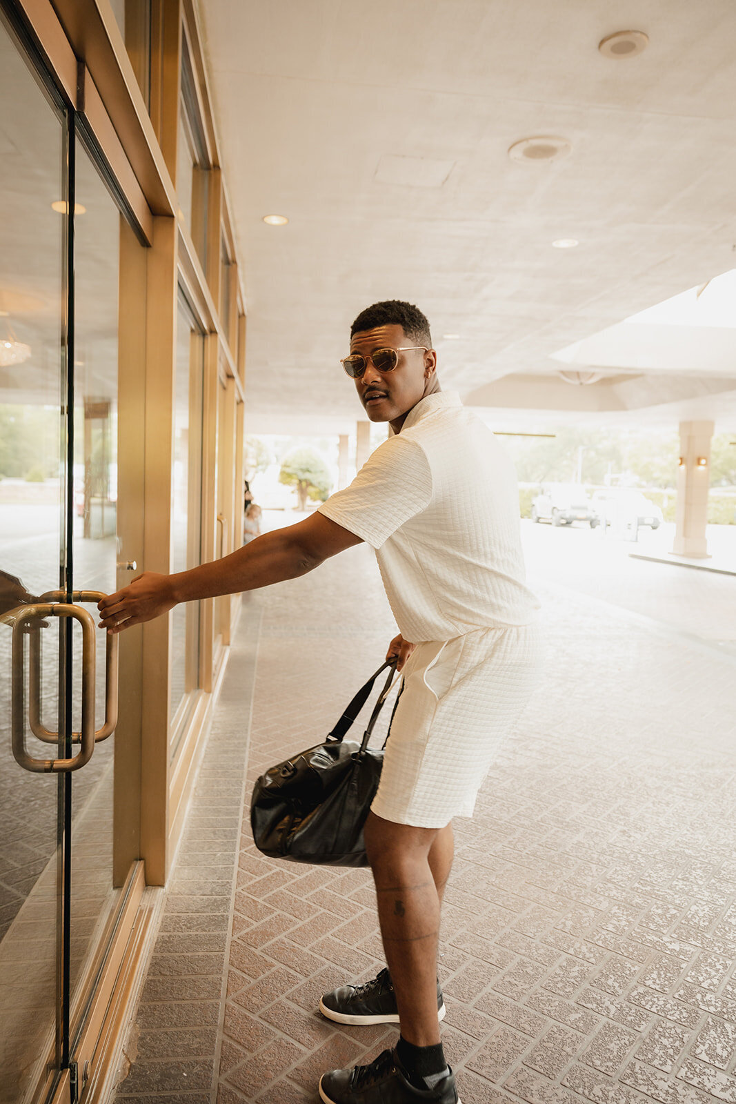 black groom enters venue gets ready for wedding