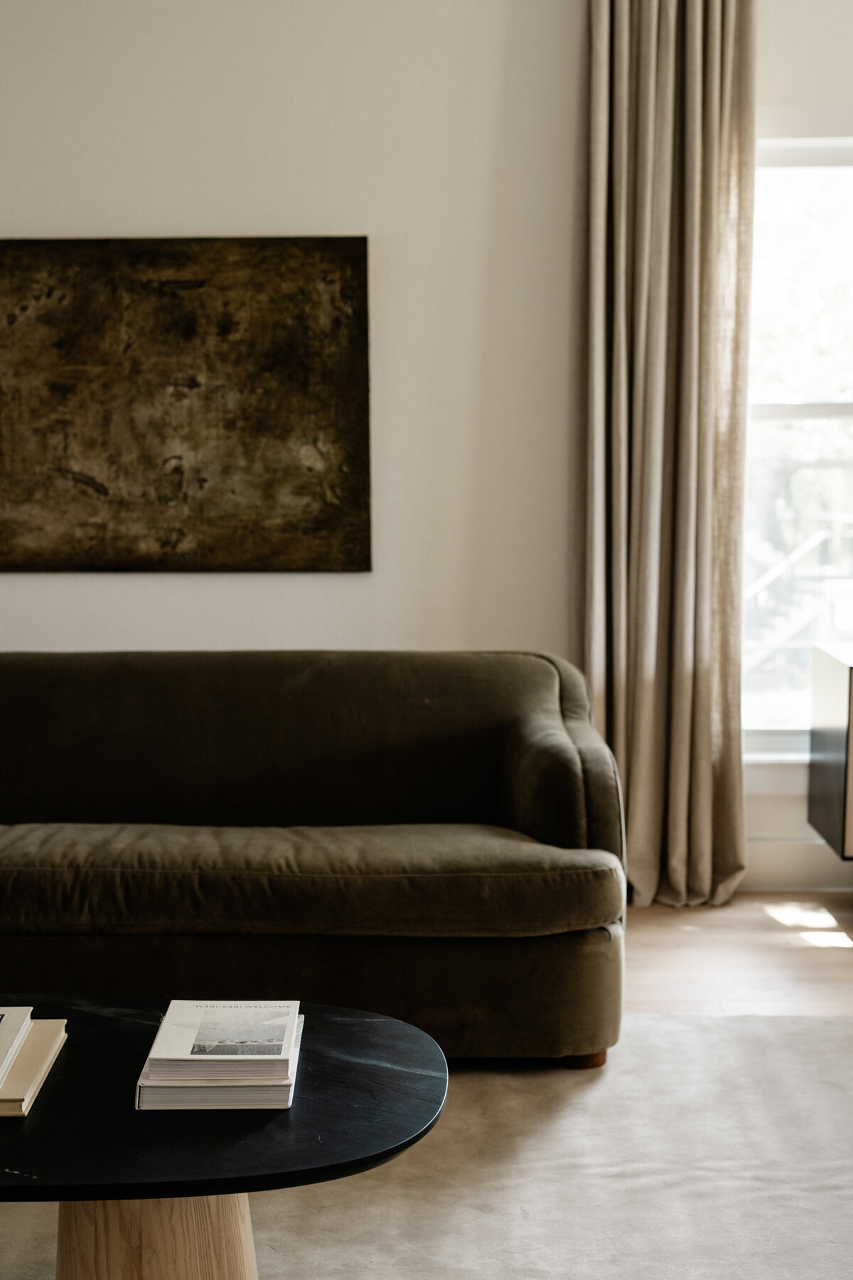 timeless-neutral-earthy-living-room-brown-green-velvet-sofa-linen-curtains-austin-house-franc