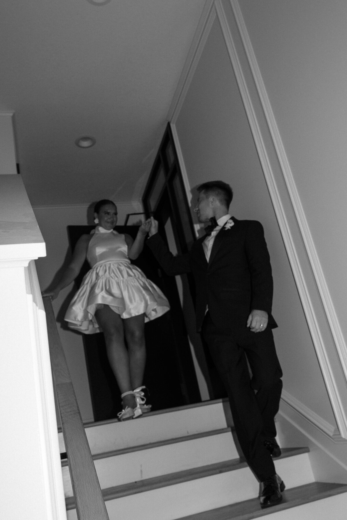 Black and White Photo of bride and groom wedding dress change 