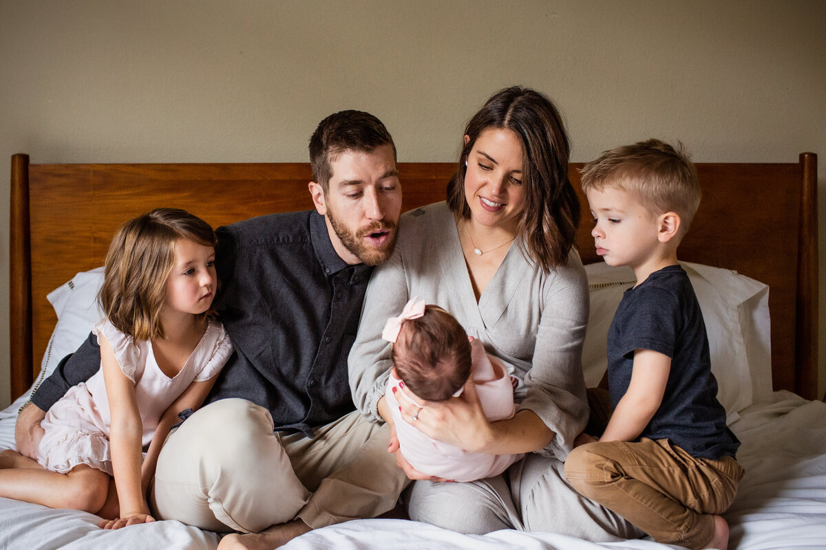 Family welcomes their new baby at an in-home lifestyle newborn shoot.