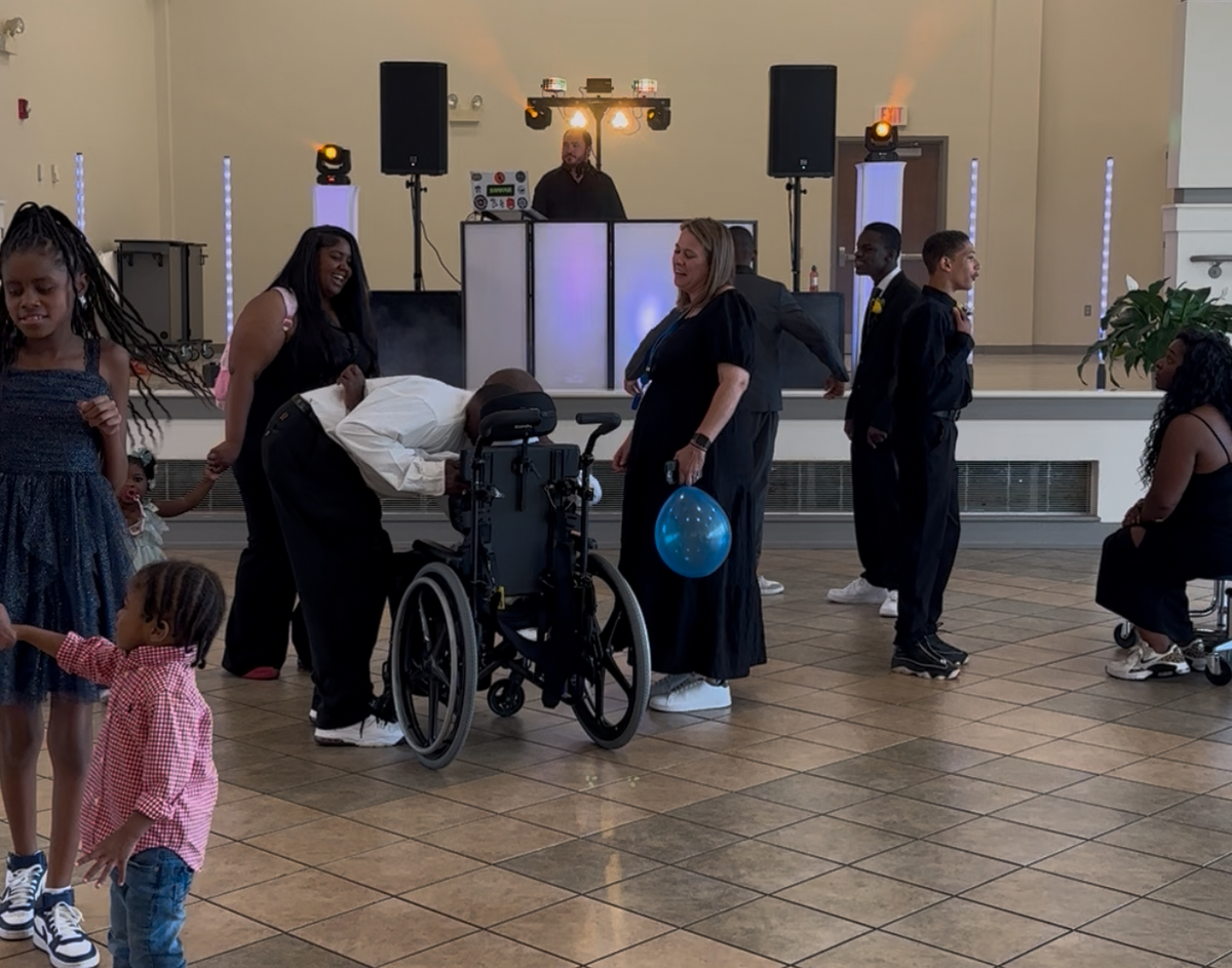 School Dance for Special Needs Children and DJ playing music. 