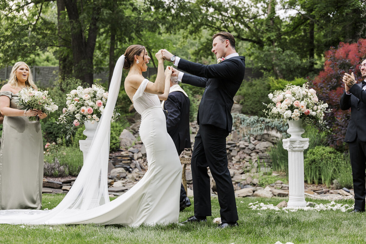 Bride and groom cheer at the end of their ceremony at their SPAF wedding