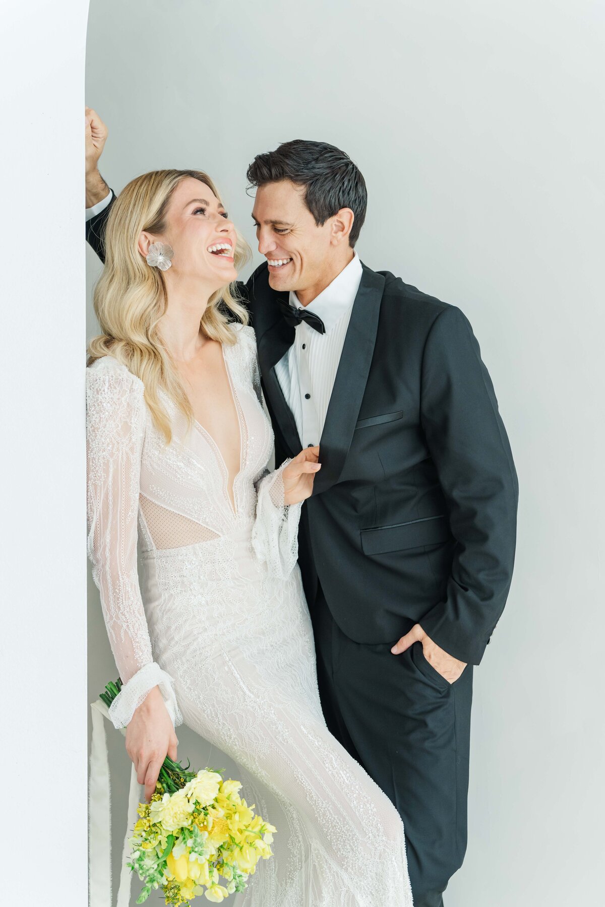 bride and groom laughing next to each other