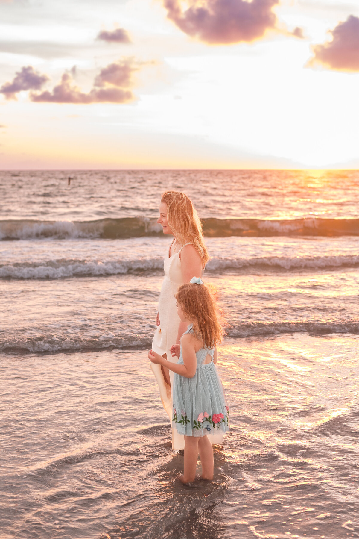 Parents and kids smiling together at sunset during an Indian Rocks Beach session.