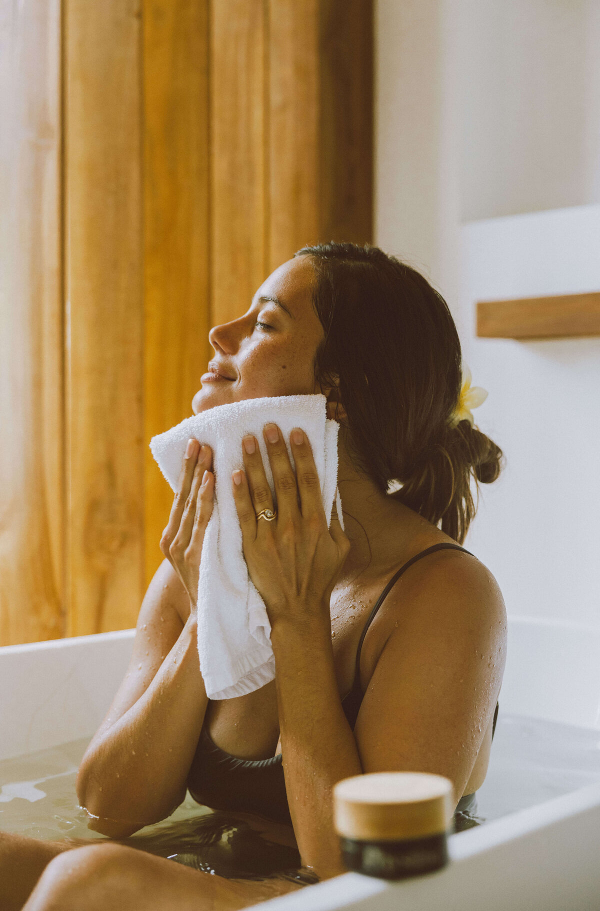 Skin care brand photography of self-care moment with towel and skincare routine