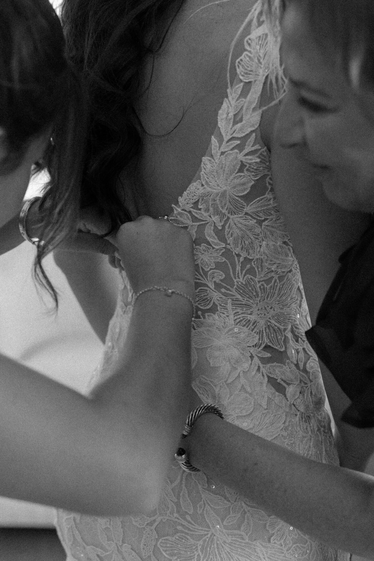 mom and sister helping bride gett ready, a closeup photo