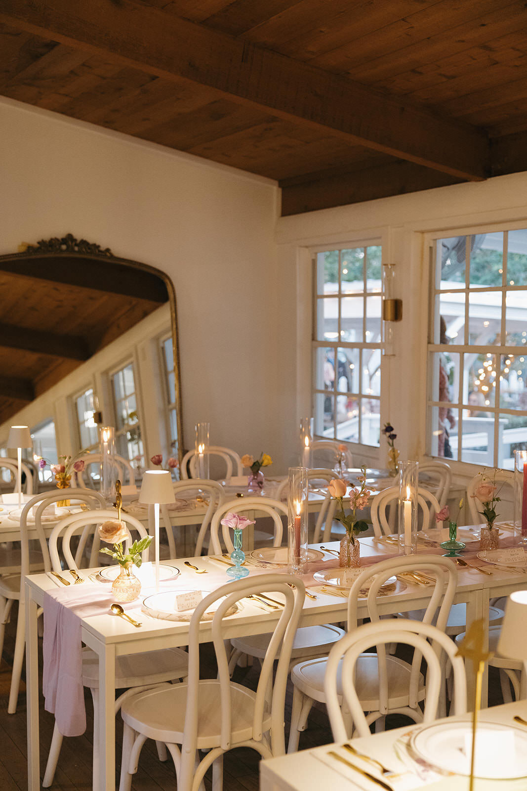Elegant indoor wedding reception with wooden chairs and natural light at Uliana Estate in Lakeland Florida.