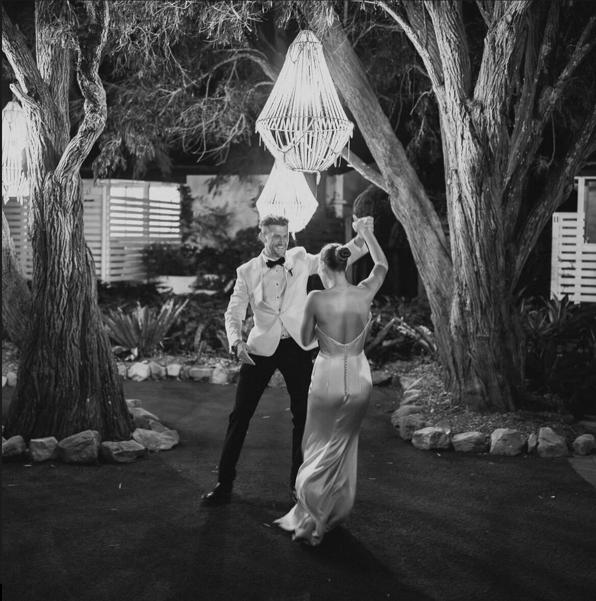 Couple performs a graceful spin during their first dance, illustrating LIMCO's philosophy of simple, smooth, and fun dance instruction.