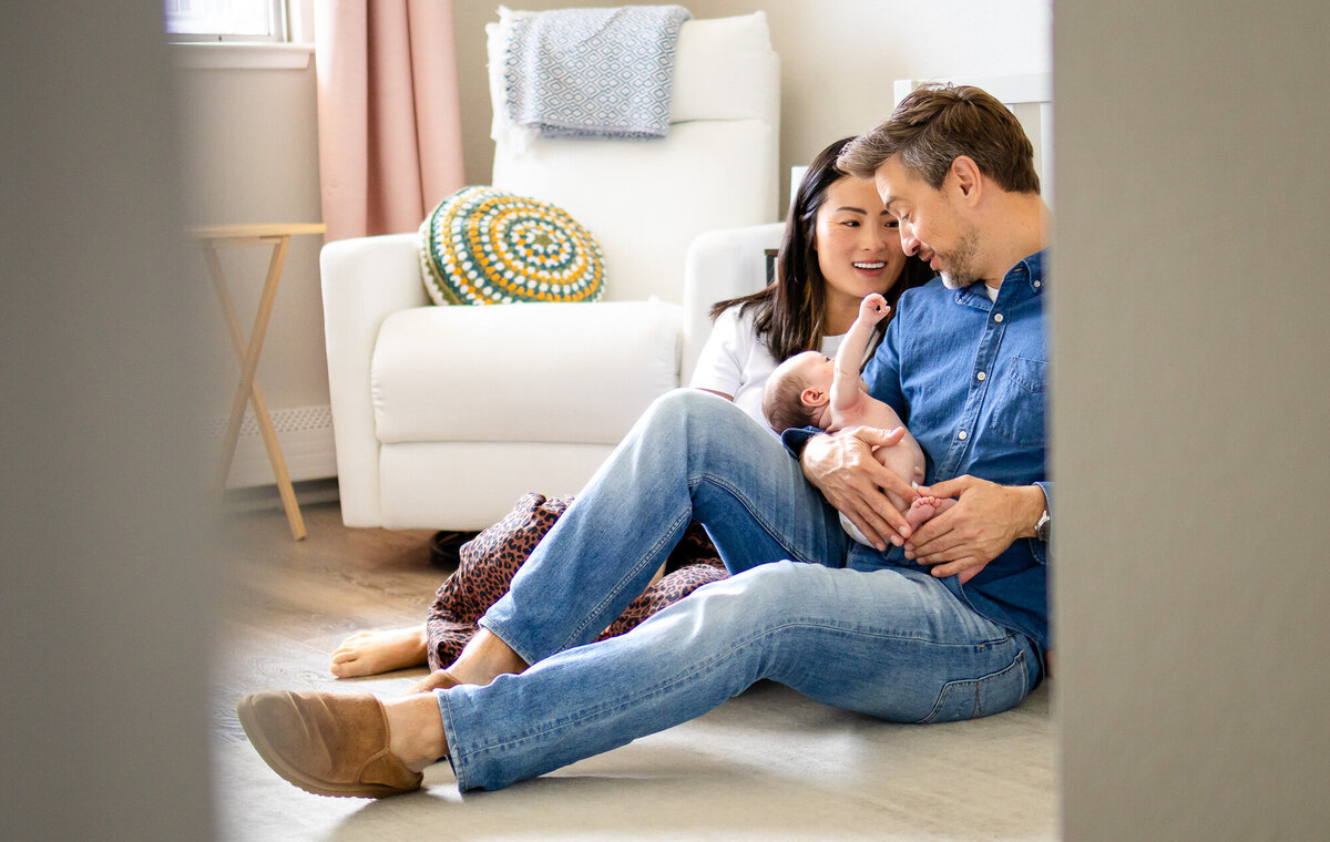Family relaxing with newborn in nursery captured by San Francisco newborn photographer