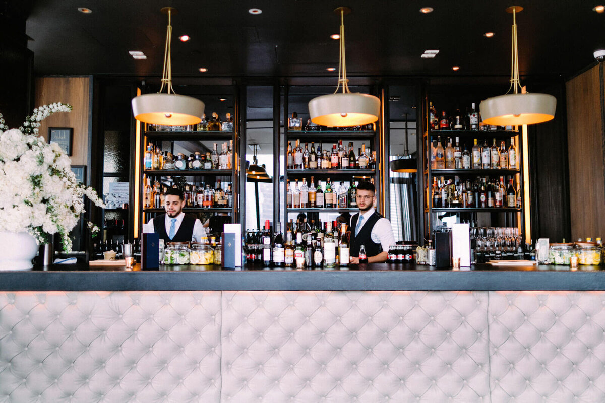 The bar tenders are preparing for the wedding reception in The Skylark, New York. Wedding Image by Jenny Fu Studio