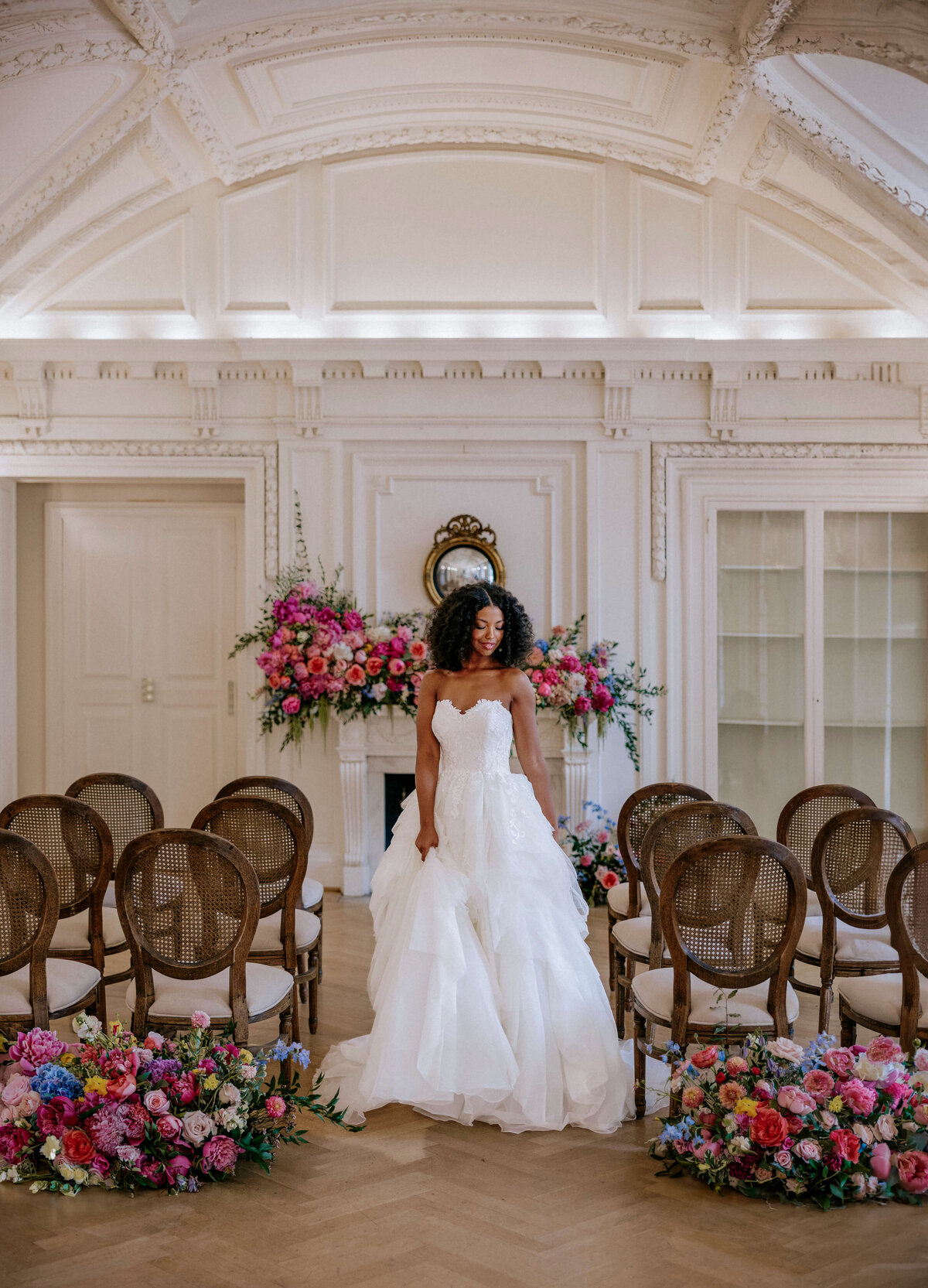 bride-posing-in-ceremony-aisle-with-colorful-flowers