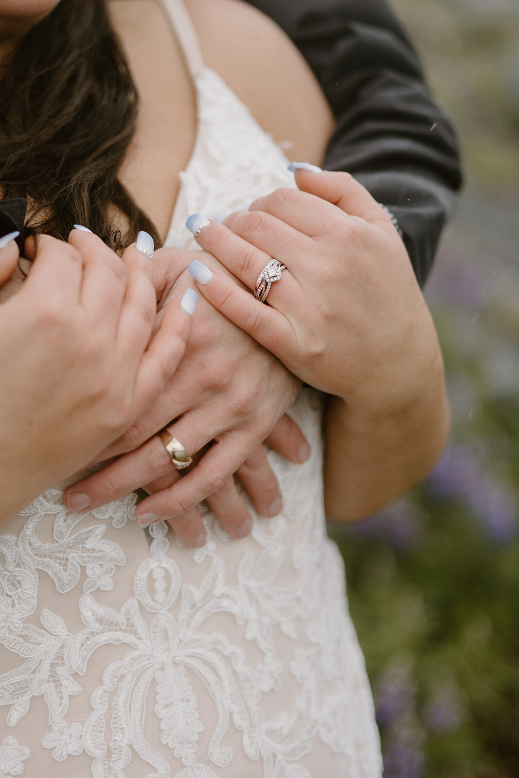 Close up of elopement couple's hands and rings.