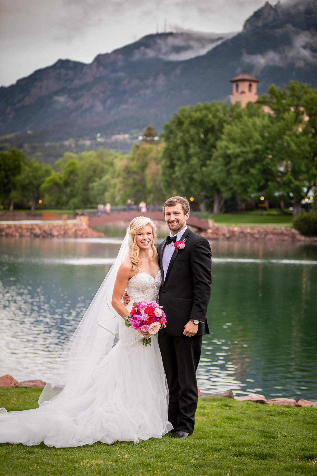 Bride and Groom pose with the Lake behind them at the Broadmoor