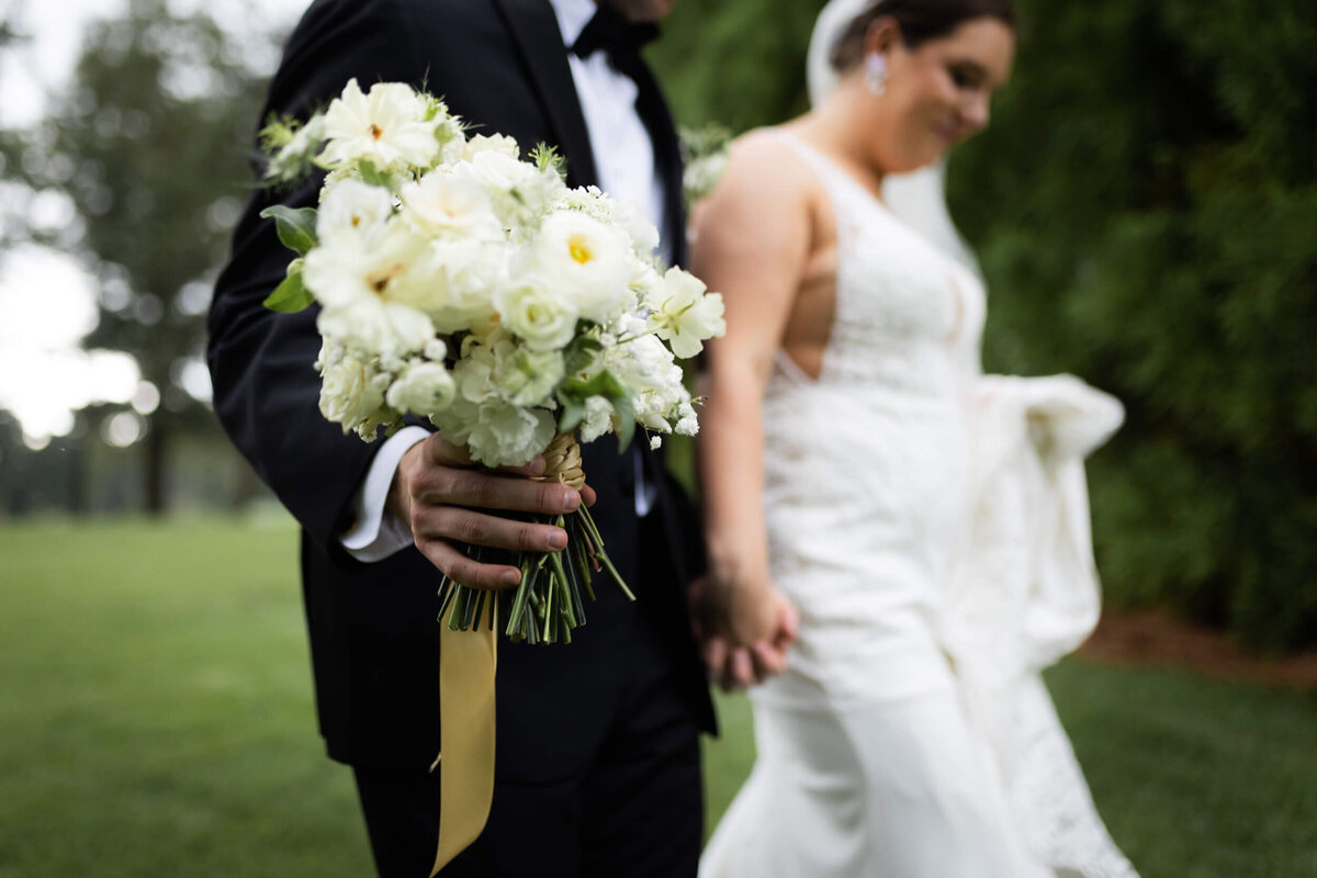 groom-holding-bouquet