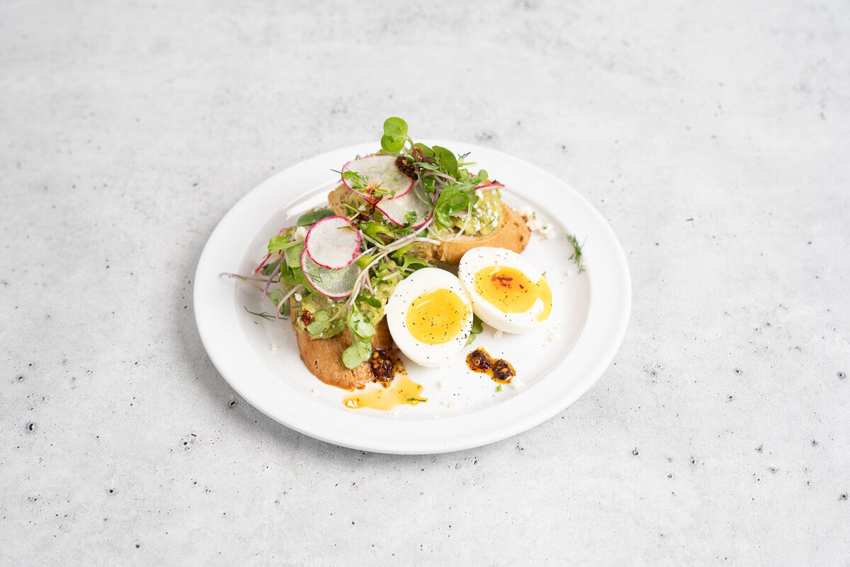 Avocado toast and an egg on a plate at Mason Dixon Bakery & Bistro
