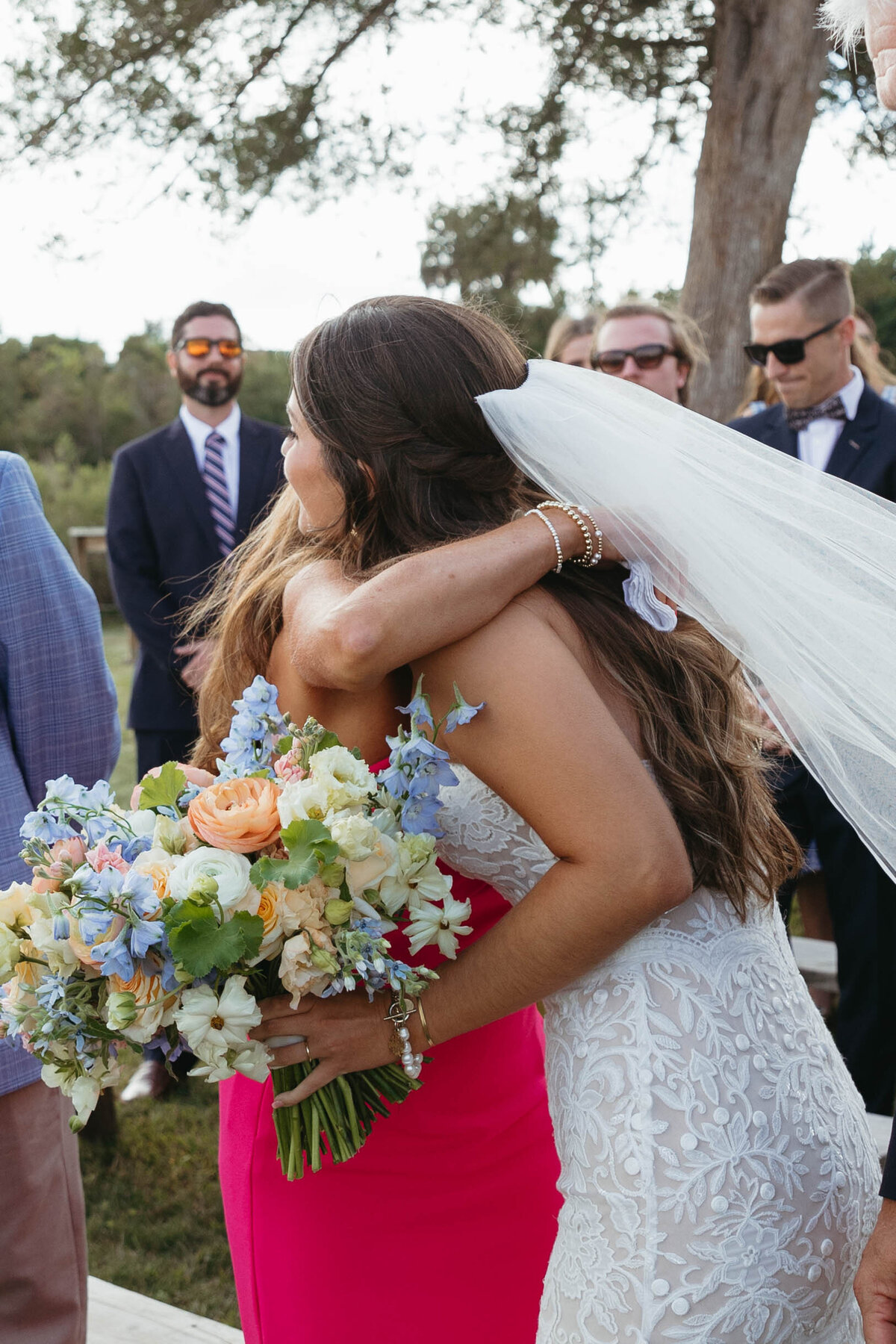 Bride hugging her mother at the altar