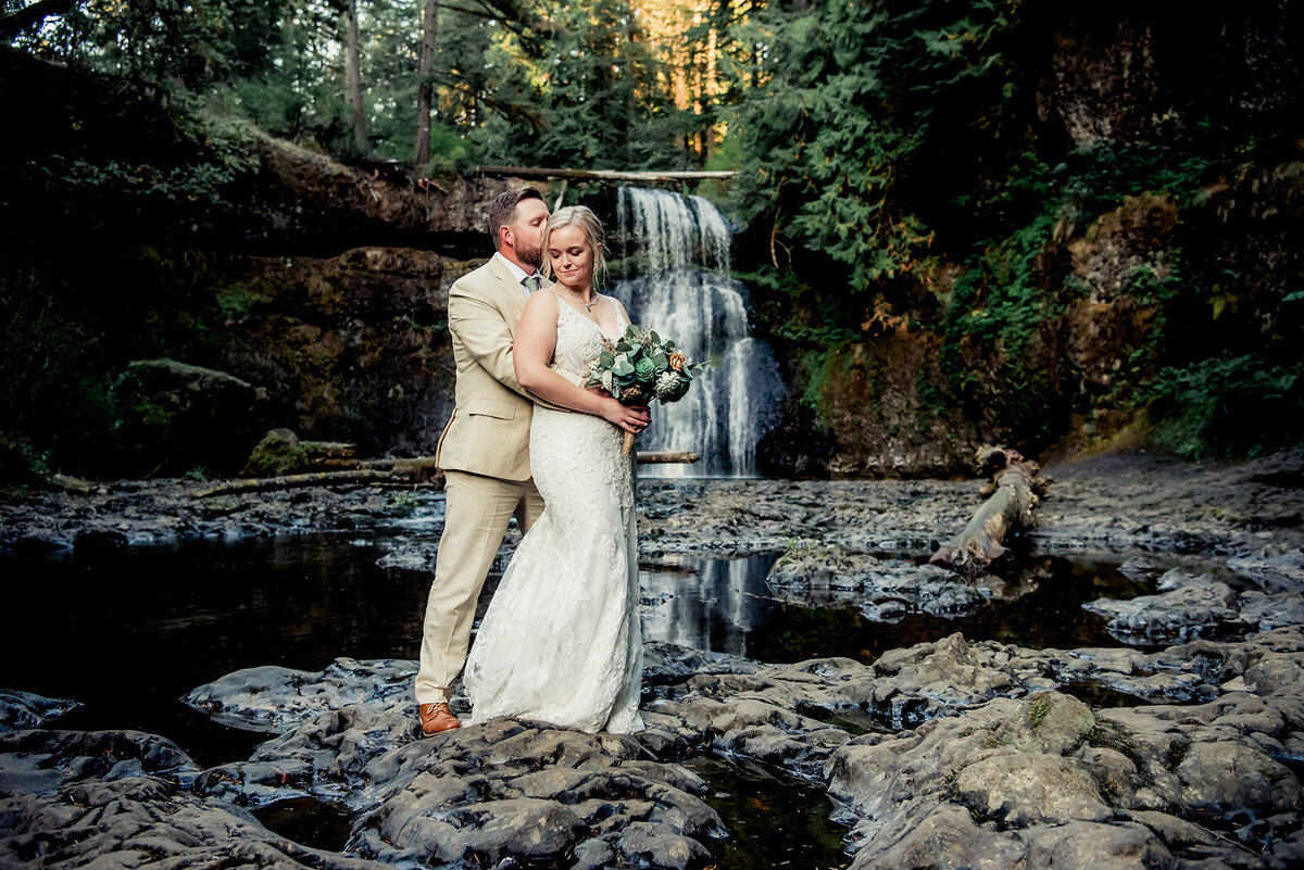 bride and groom at waterfall