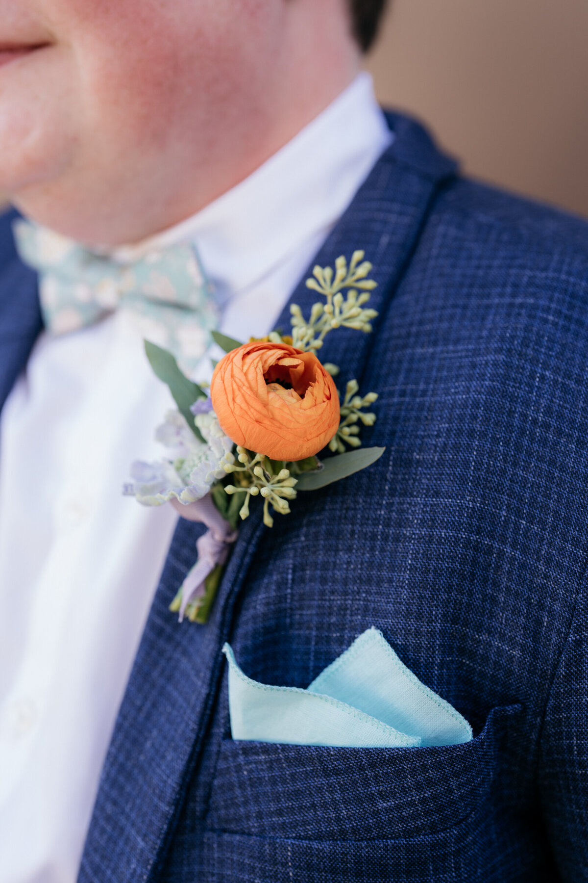 groom wearing blue silk suit