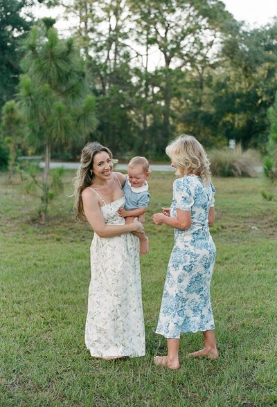 Mom holding baby and smiling next to grandmother for florida engagement photography by Shelby Ann Photos