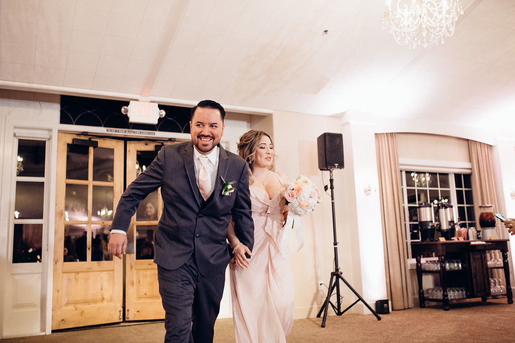 Wedding Photograph Of Groomsman And Bridesmaid Walking Inside The Reception Hall Los Angeles