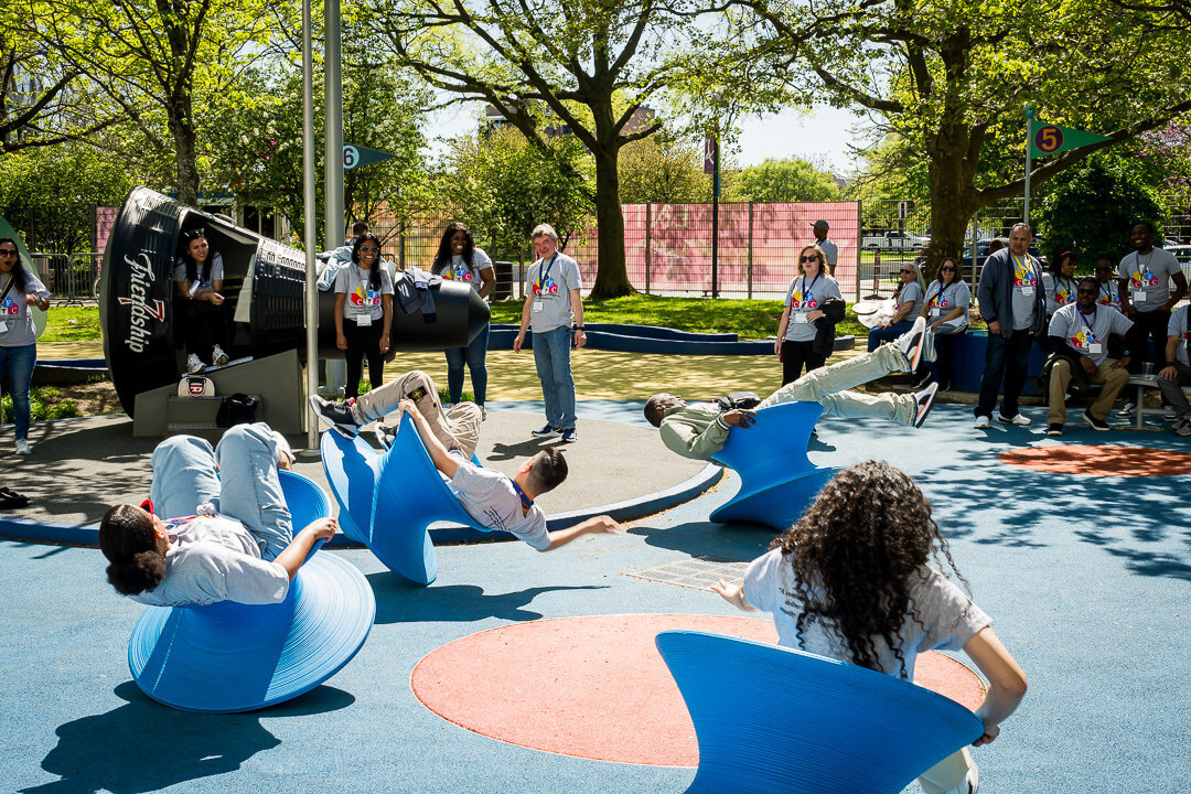 Corporate event photo of employees stretching during outdoor workshop at business retreat new york.