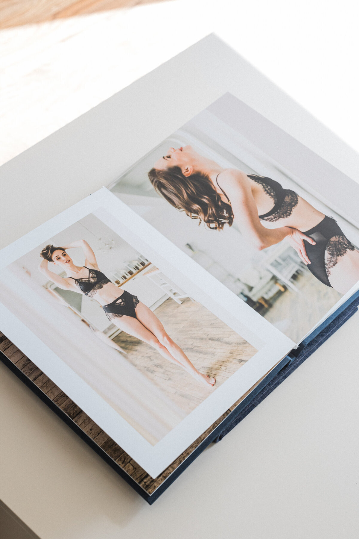 Open boudoir album displaying candid, romantic images from a bridal session