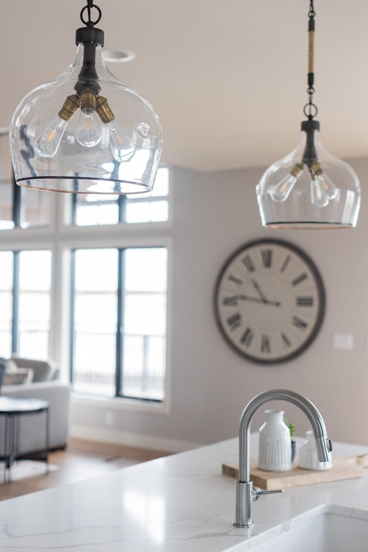 michele rosenboom design modern farmhouse kitchen island with light fixtures handing with clock on wall