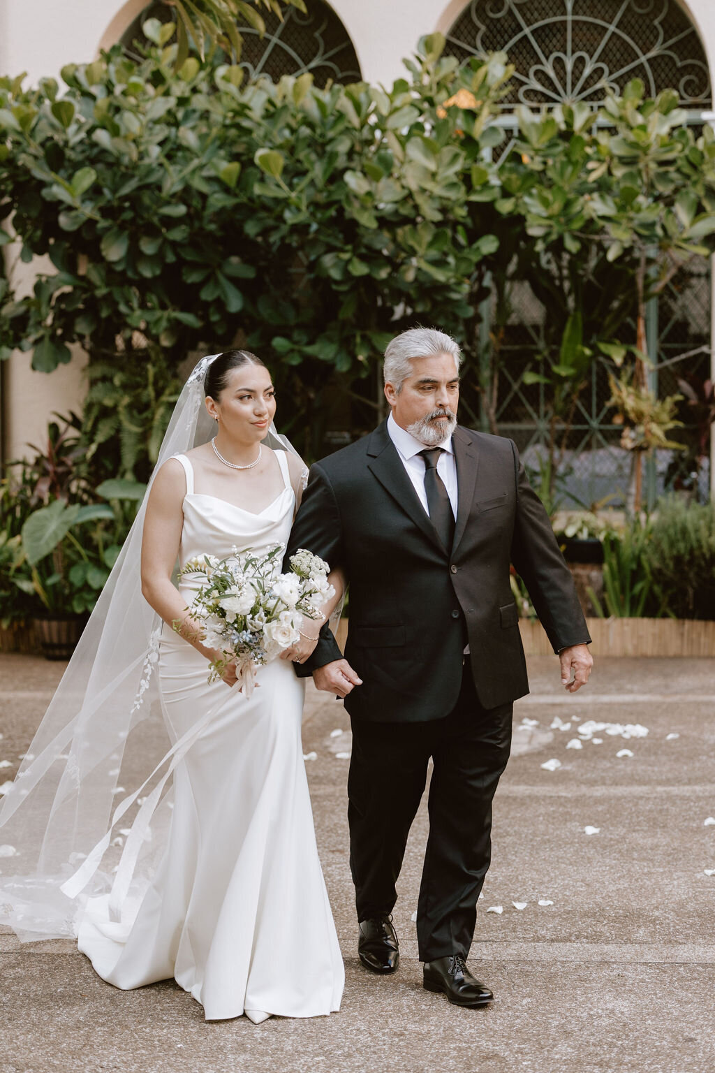 Bride walking towards the aisle with her father arm in arm