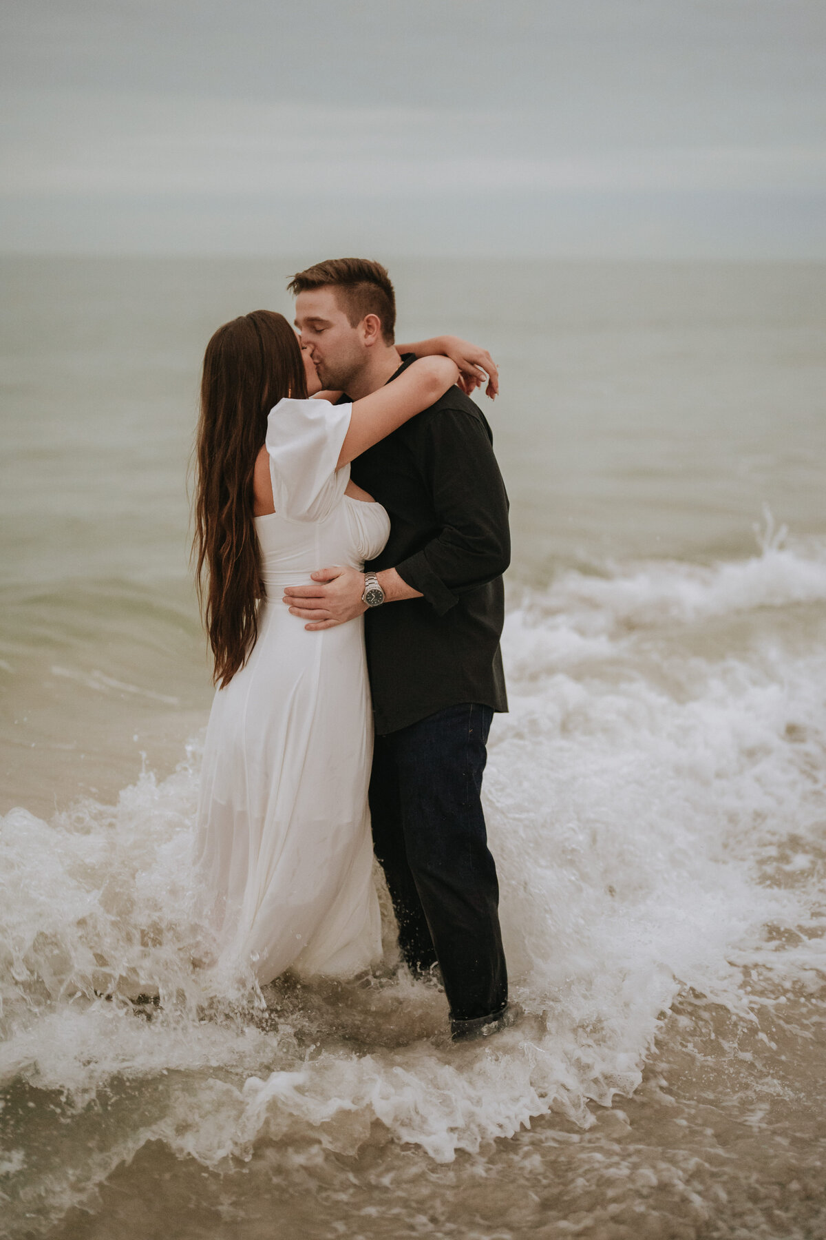 couple kissing in the ocean at johns pass in treasure island  florida