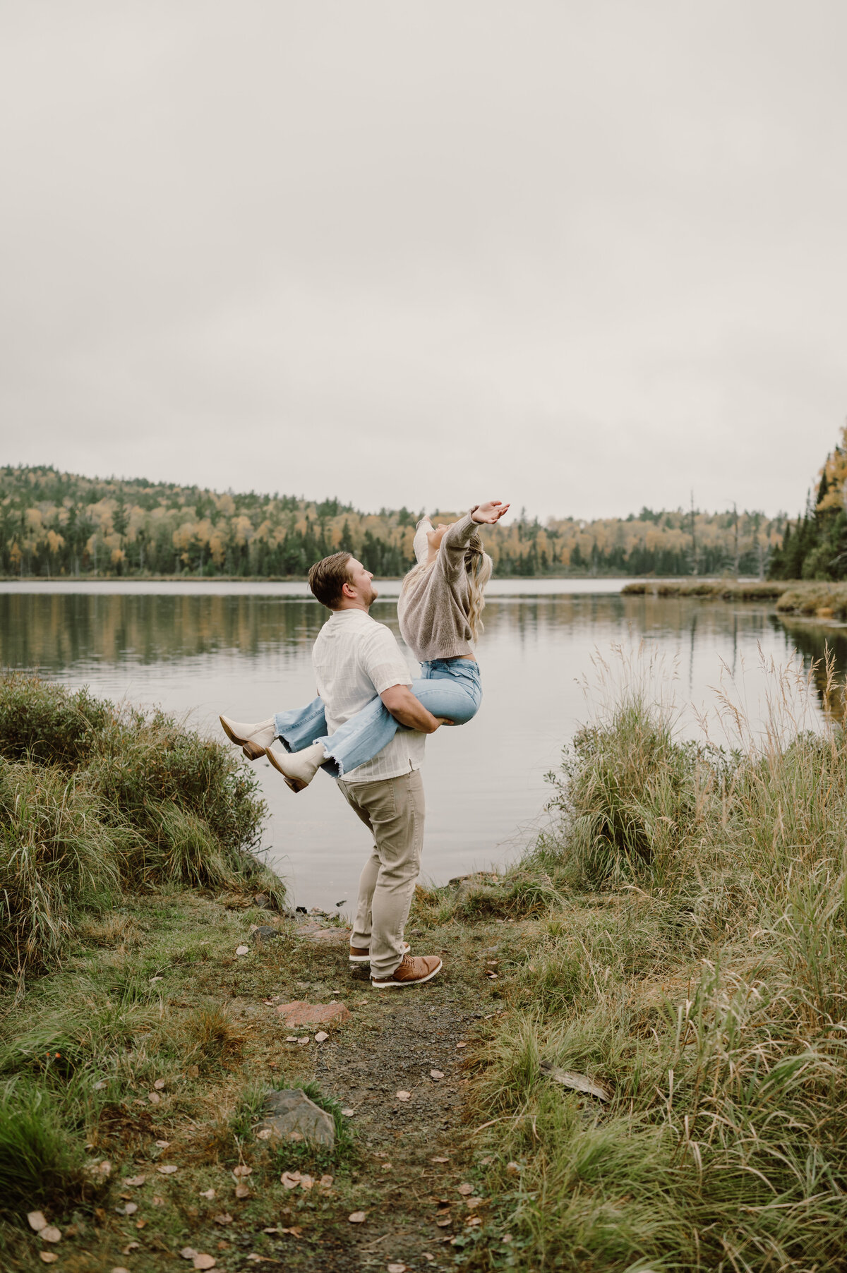 a boy spin his girl in the air