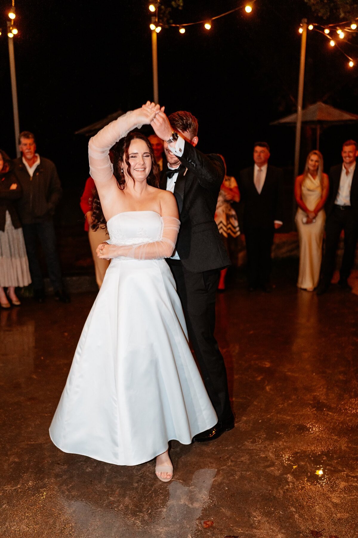 A blissful moment captured: a couple joyfully dances at their wedding reception, encapsulating love and celebration in a single frame.