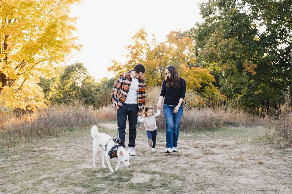 Toronto family photographer capturing a playful moment at High Park in the fall.