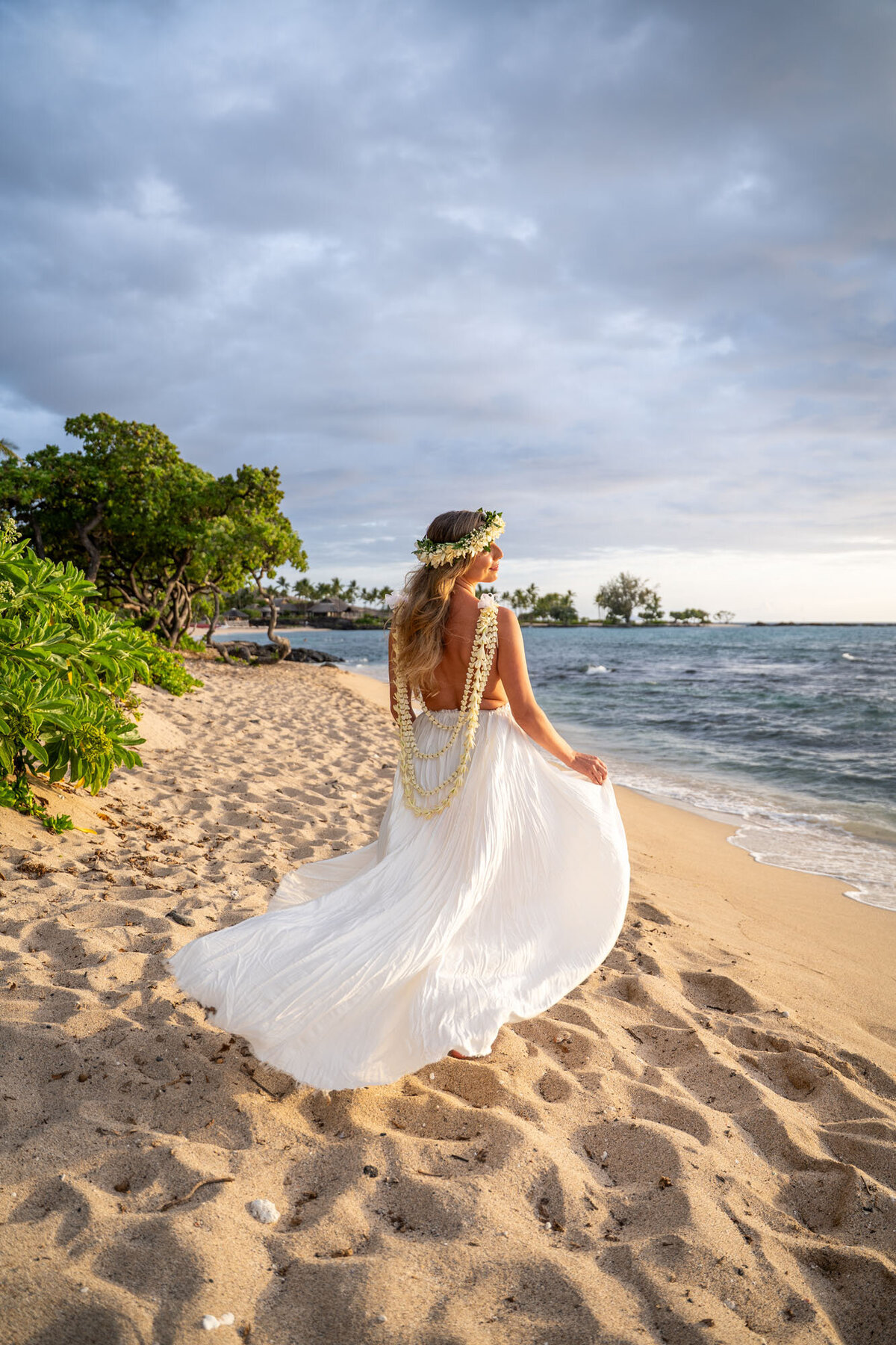 wedding photography big island hawaii with bride running in the wind on Kukio beach
