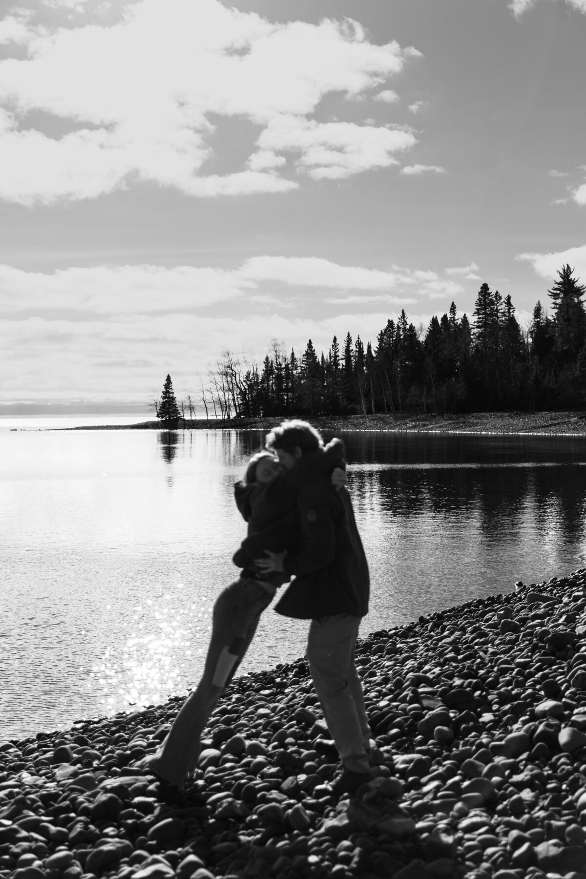 Cute black and white couples photo hugging on the beach 