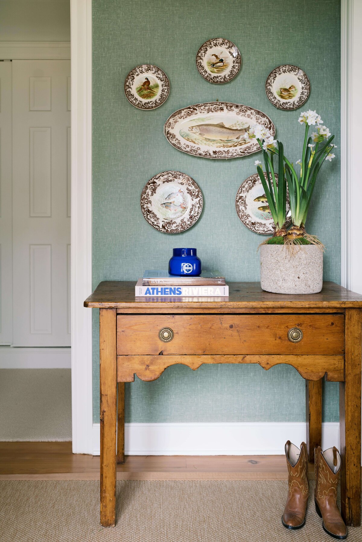 oyster creek studios happy valley fish plaques on blue wall with a wooden side table