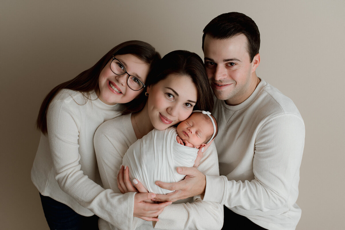 Family in studio session with newborn in Northwest Ohio