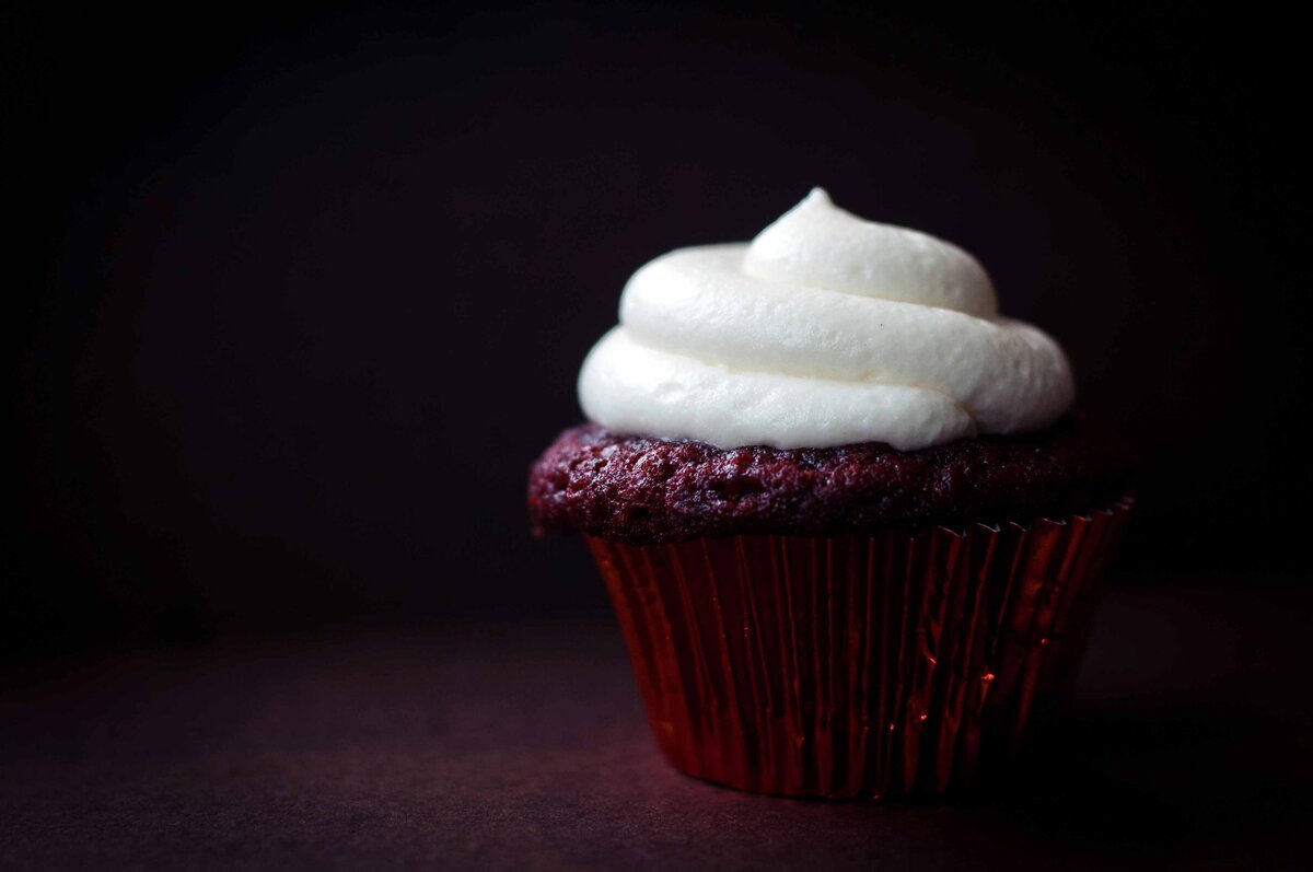 a chocolate cupcake with white frosting