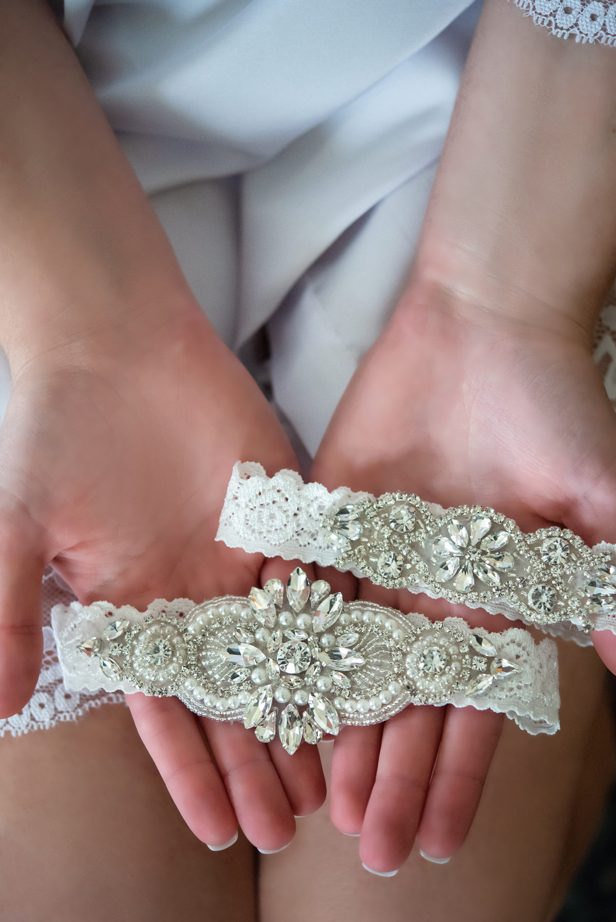 bride holds garter set
