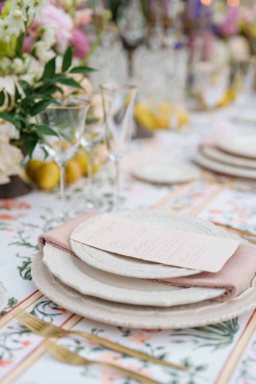 reception table decorated with plates and flowers