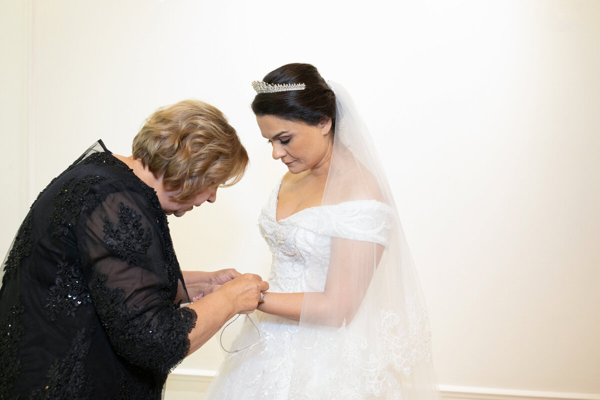 mother-helping-bride-with-jewelry-callanwolde-wedding-details