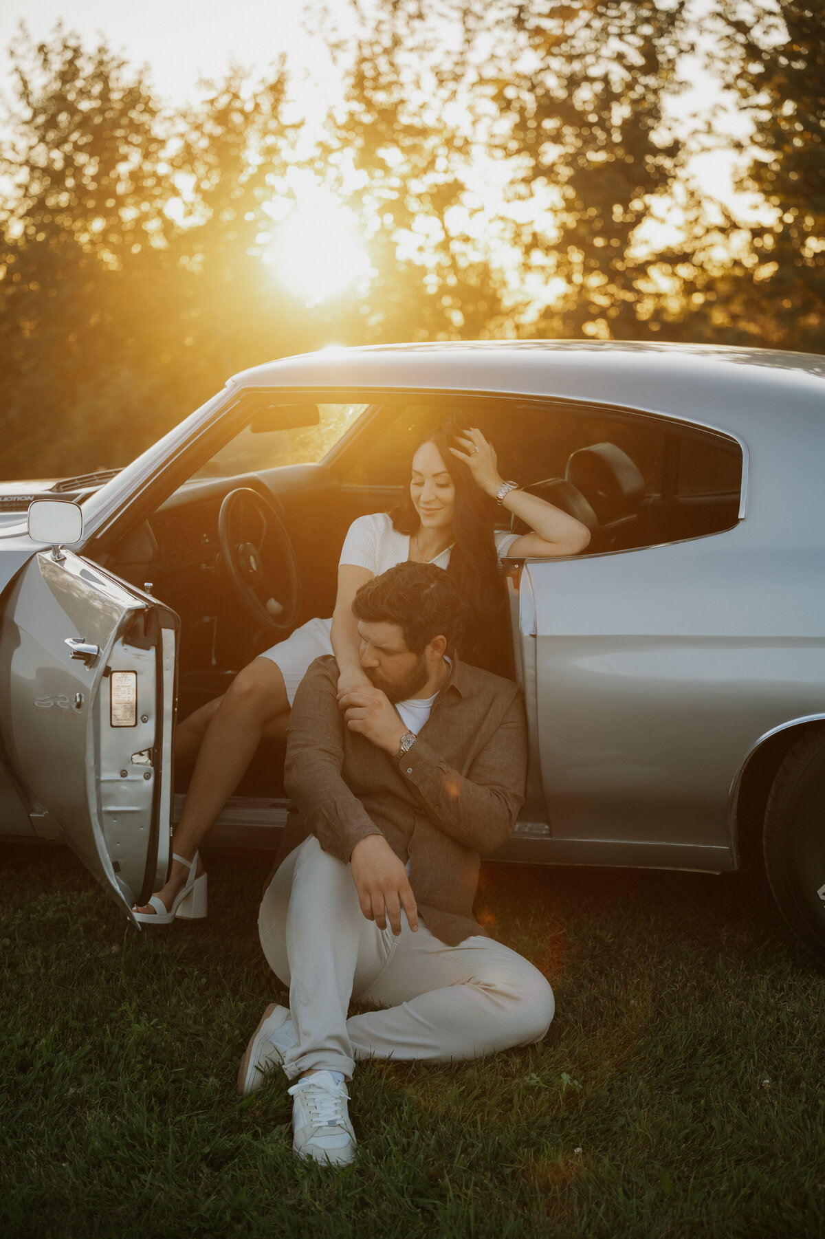 Engaged couple photo with their sports car taken in Alberta