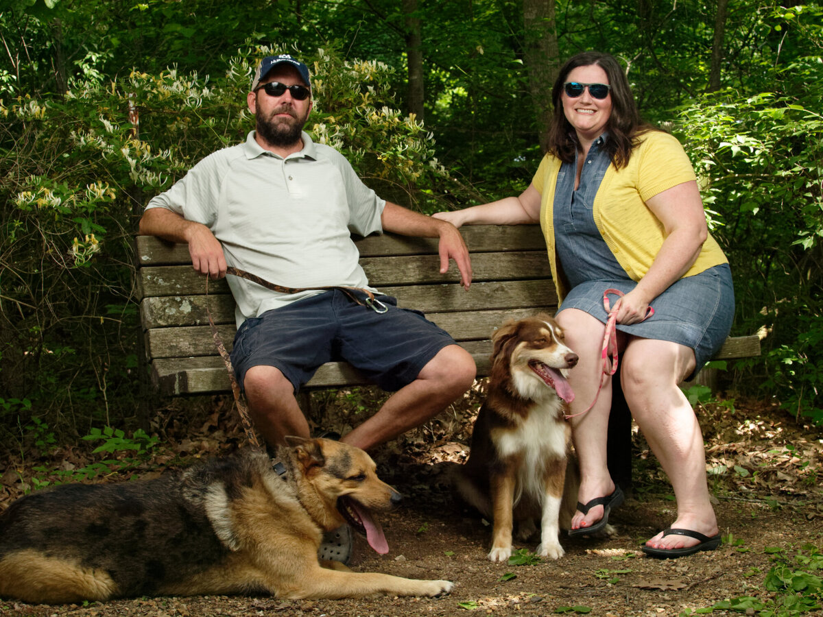 husband and wife with dogs outdoor daytime portrait