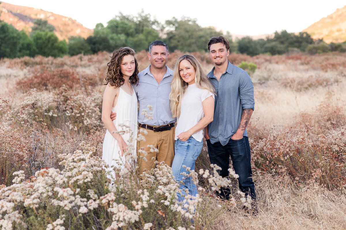 family standing in field of tall grass san diego