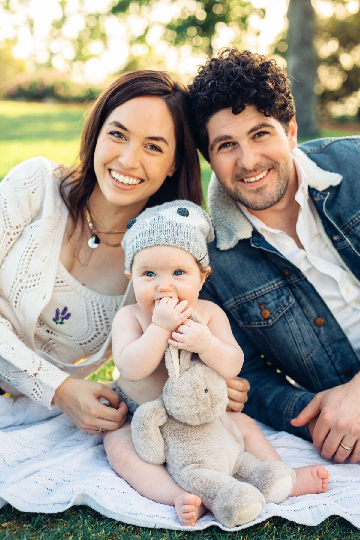 Family Portrait Photo Of Couple Sitting On The Ground With Their Baby In Los Angeles