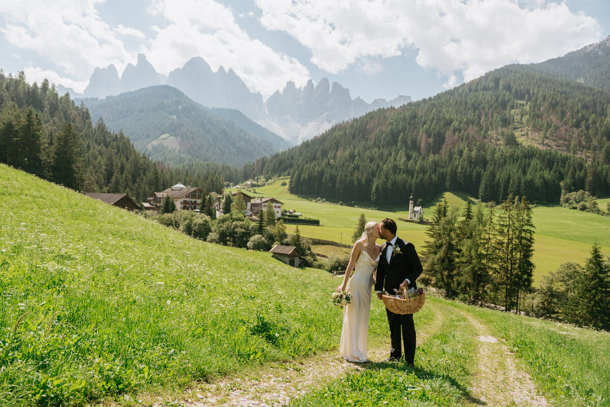 Couple kissing with Dolomites peaks in background