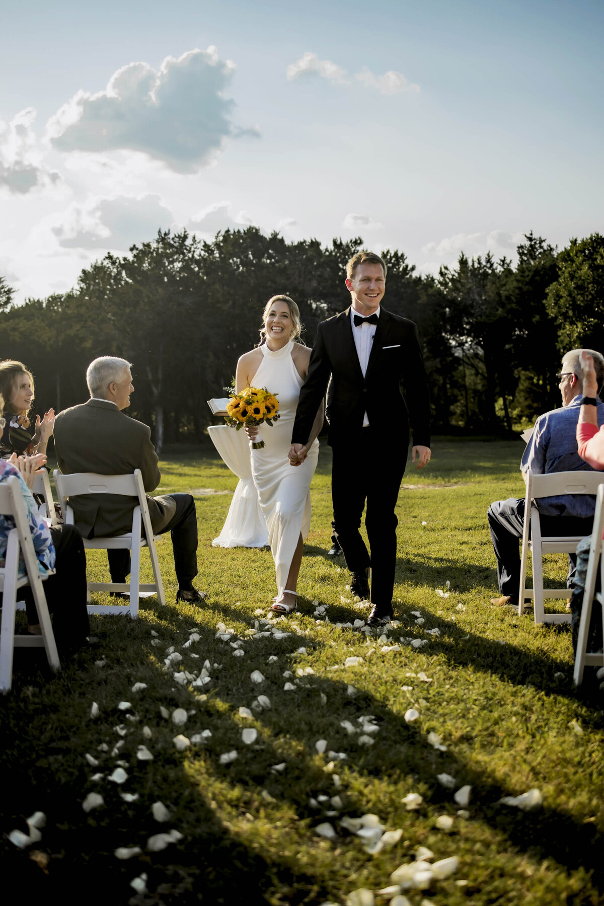 a bride and groom walk back down the isle