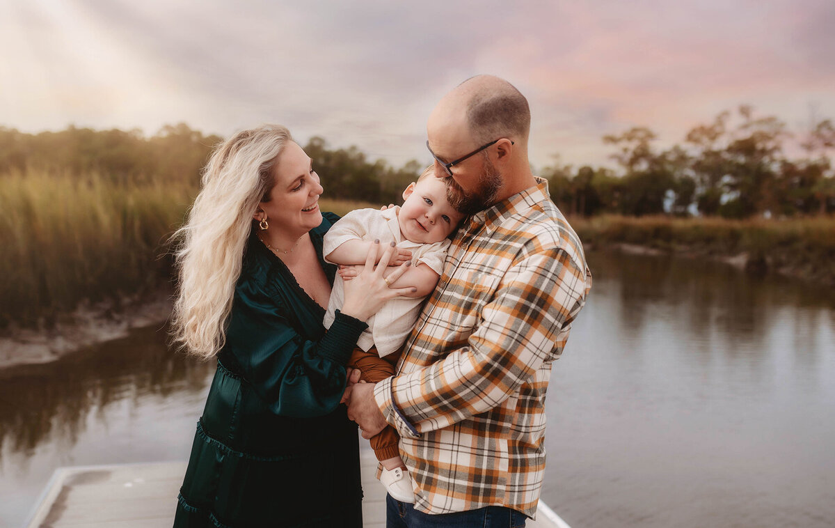 Parents embrace their baby during Family Photos in Charleston.