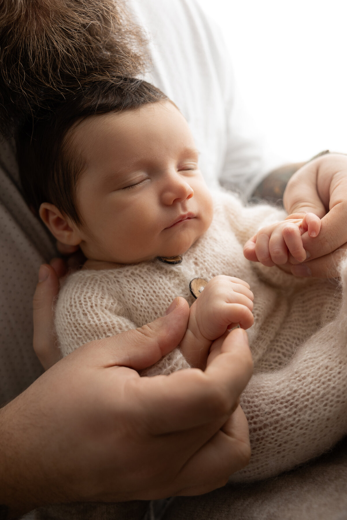 Backlit high contrast studio newborn pose 