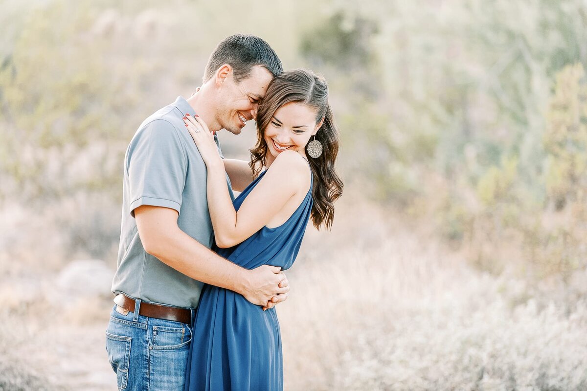 engaged-couple-laughing-in-desert