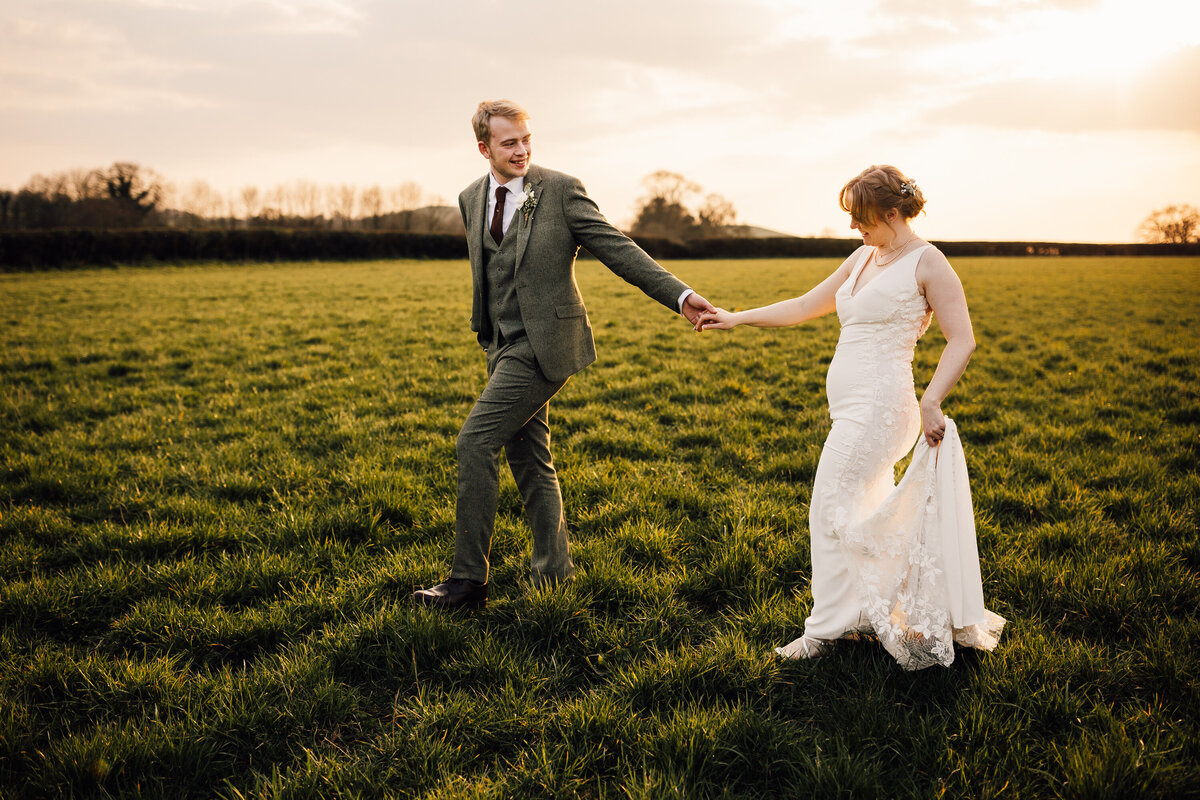 Bride and Groom portrait in garden field at sunset
